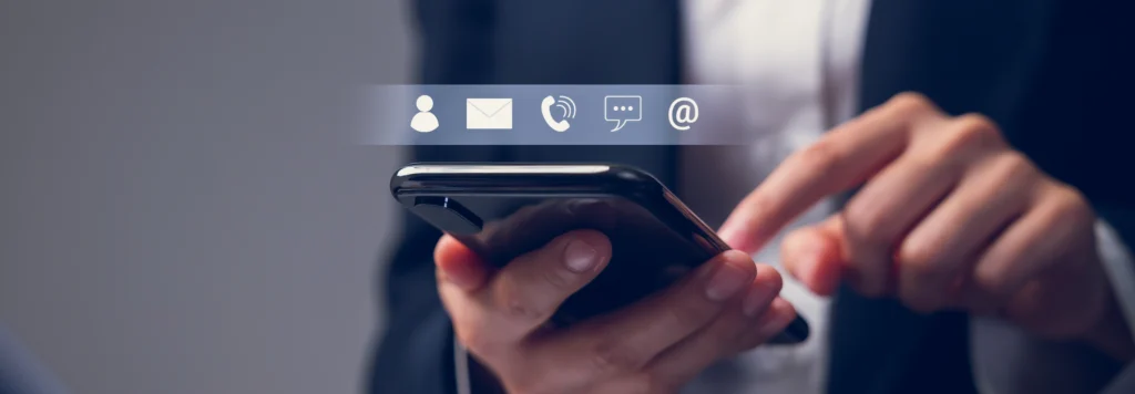 Person using a smartphone with contact icons